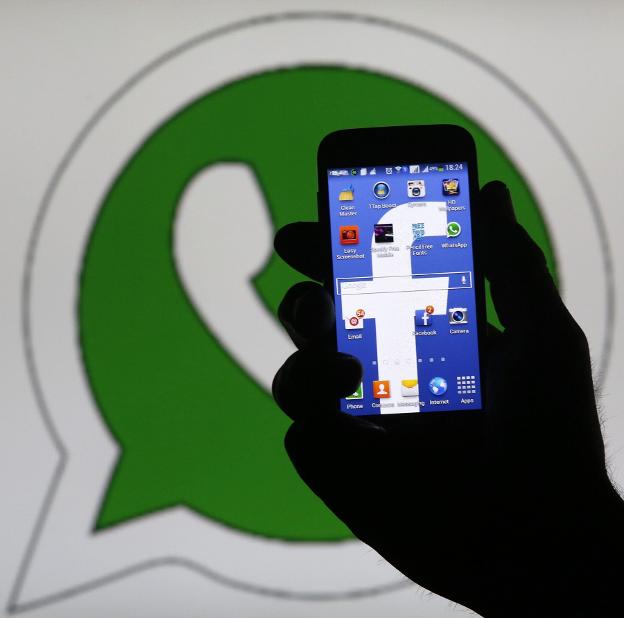 Móvil con el logo de Facebook, ante el icono de Whatsapp. :: reuters/